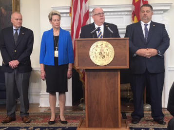 Gov. Lawrence J. Hogan announces a series of proposals to beef up school safety in the State House Wednesday. He is joined by Ed Clarke, left, executive director of the Maryland Center for School Safety; Dr. Karen Salmon, state superintendent of schools; and Glenn Fueston, executive director of the Governor’s Office of Crime Control & Prevention. Photo by Bruce DePuyt