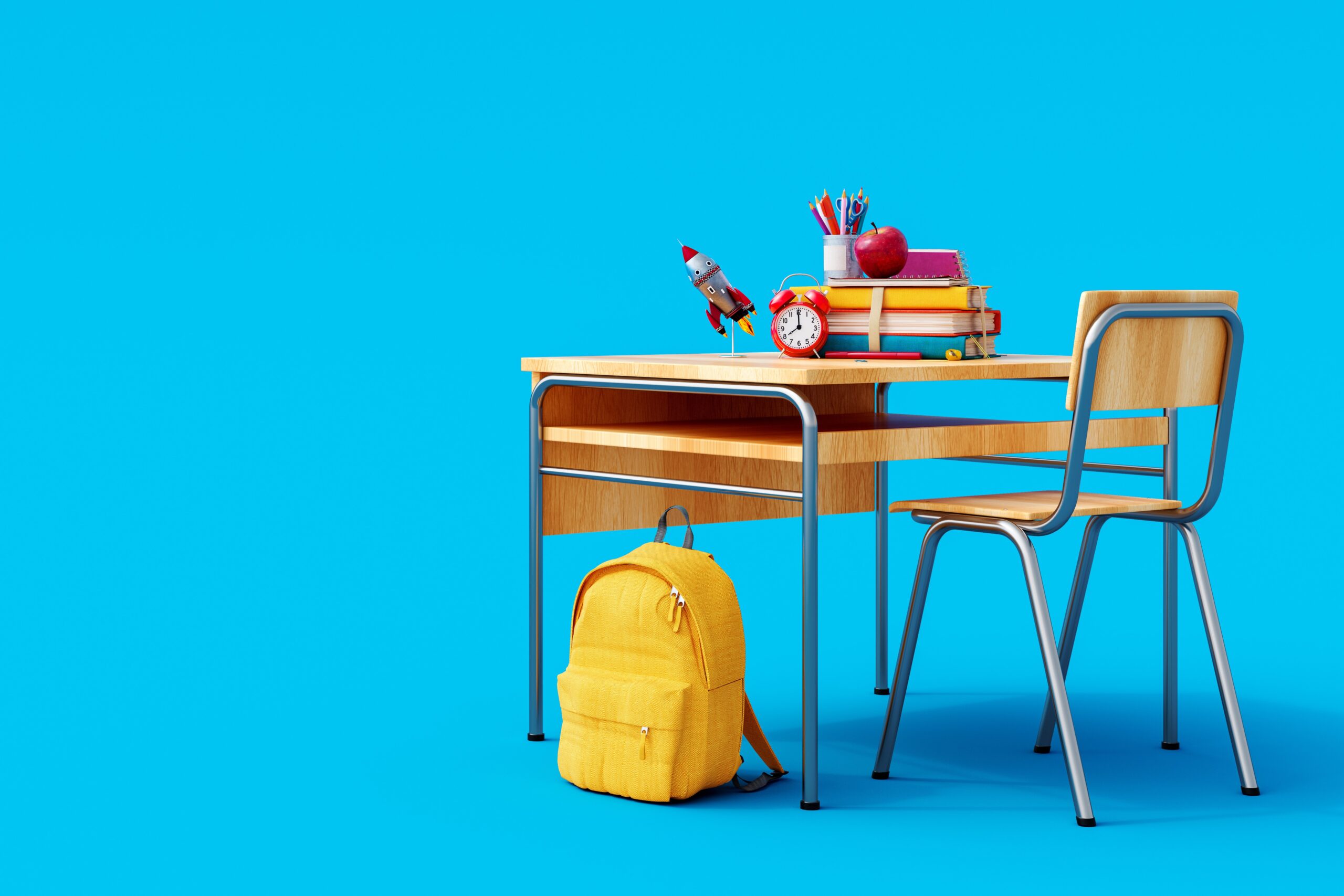 School desk with school accessory and yellow backpack