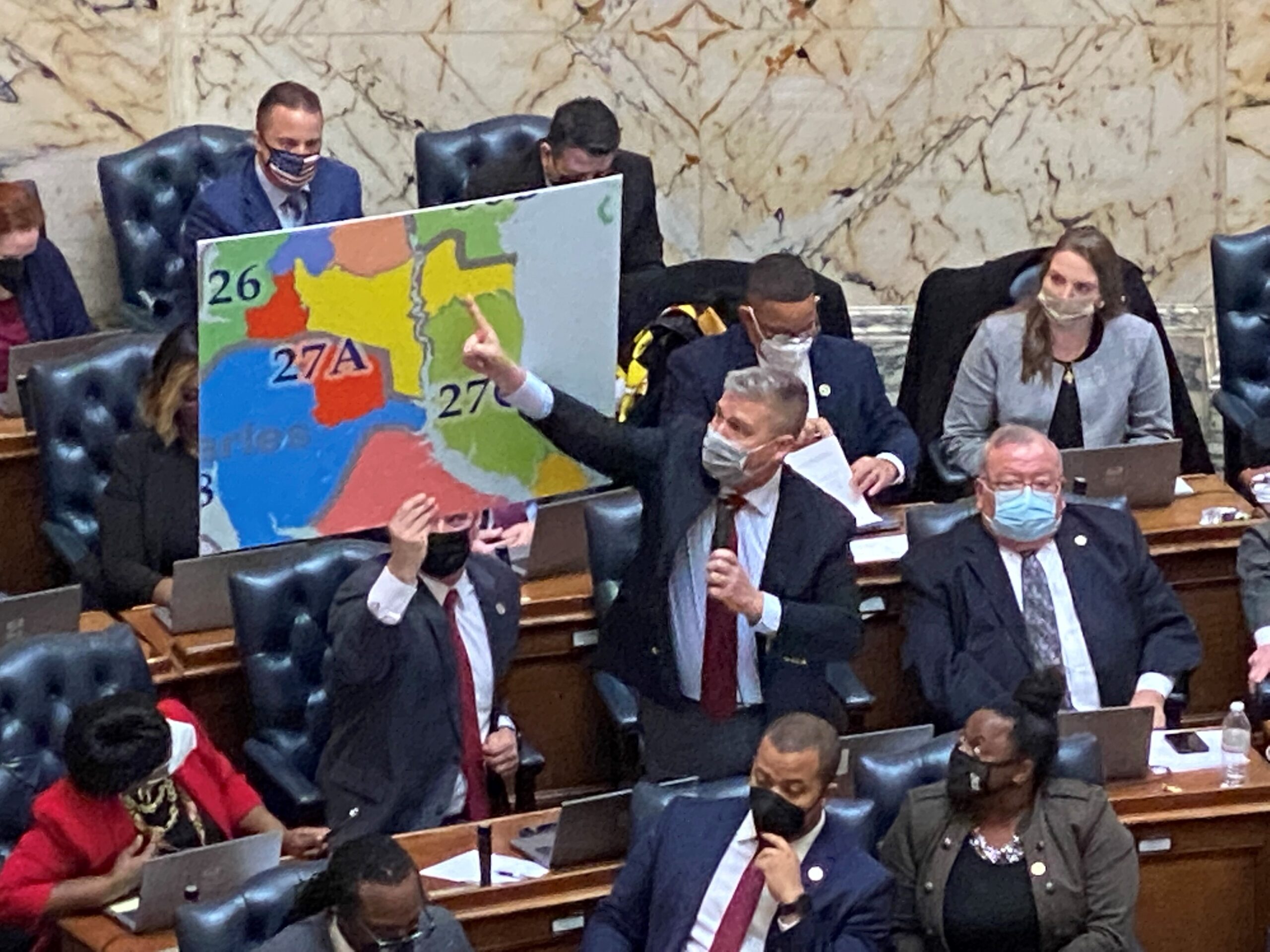 Del. Mark N. Fisher points to a district map on the House floor