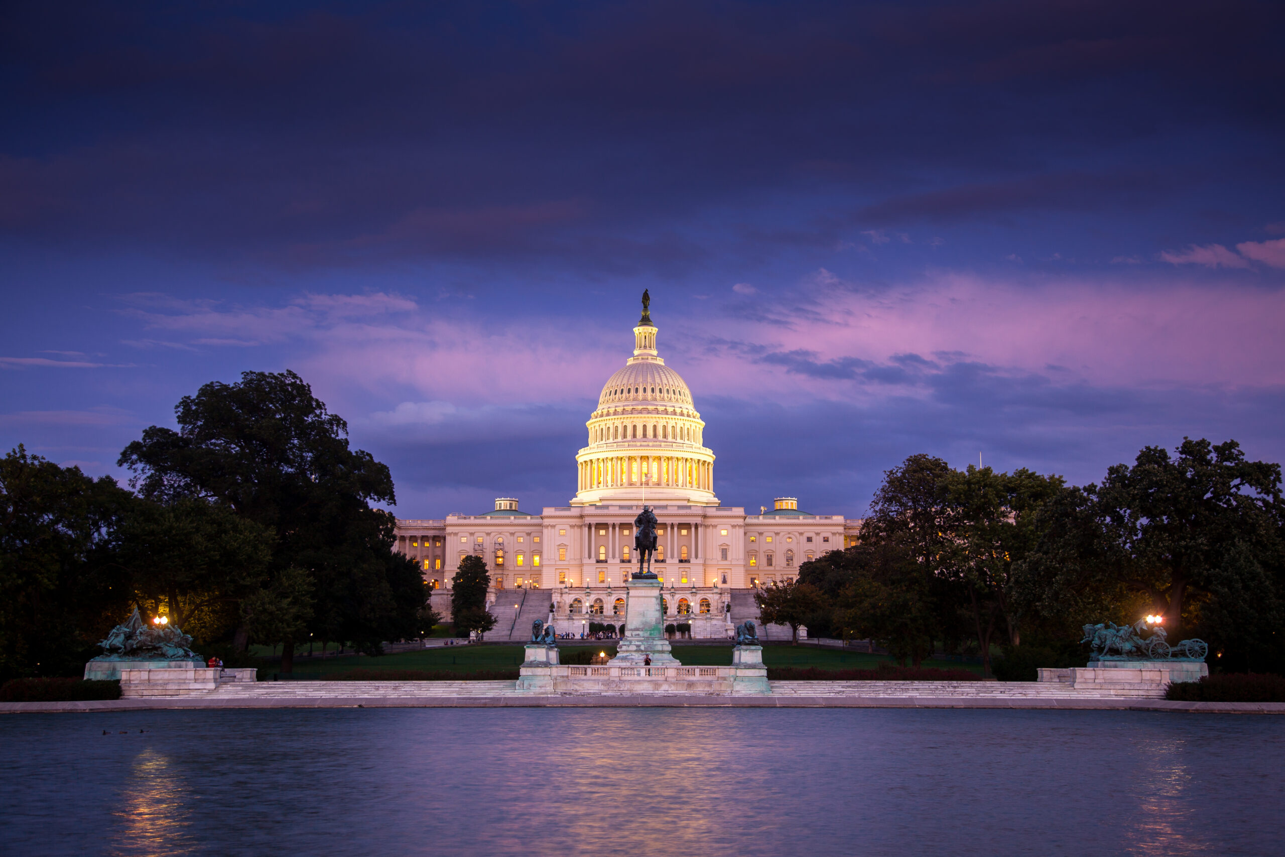 The U.S. Capitol building under a purple sky