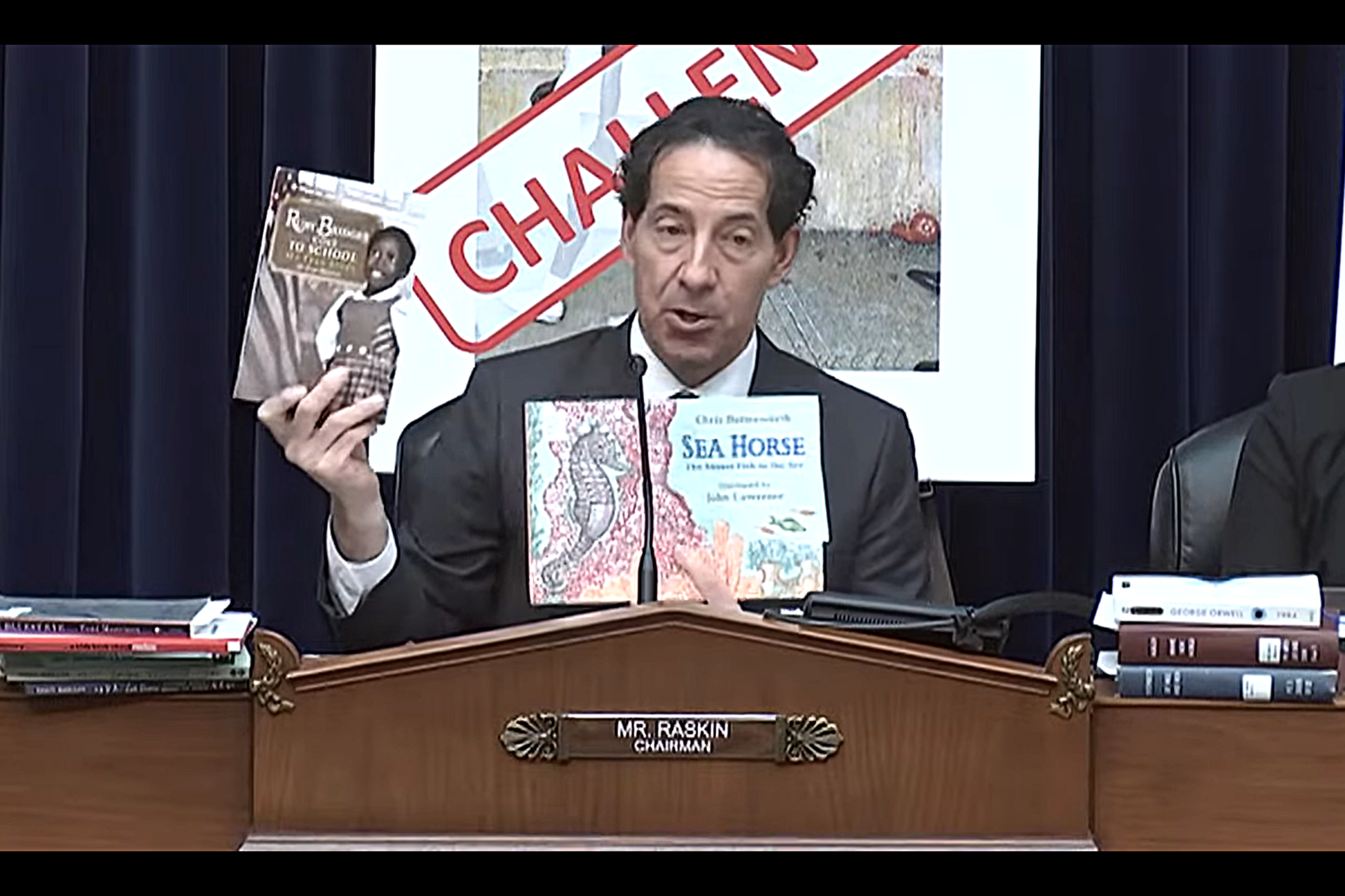 Rep. Jamie Raskin (D-Md.) holds up two banned books